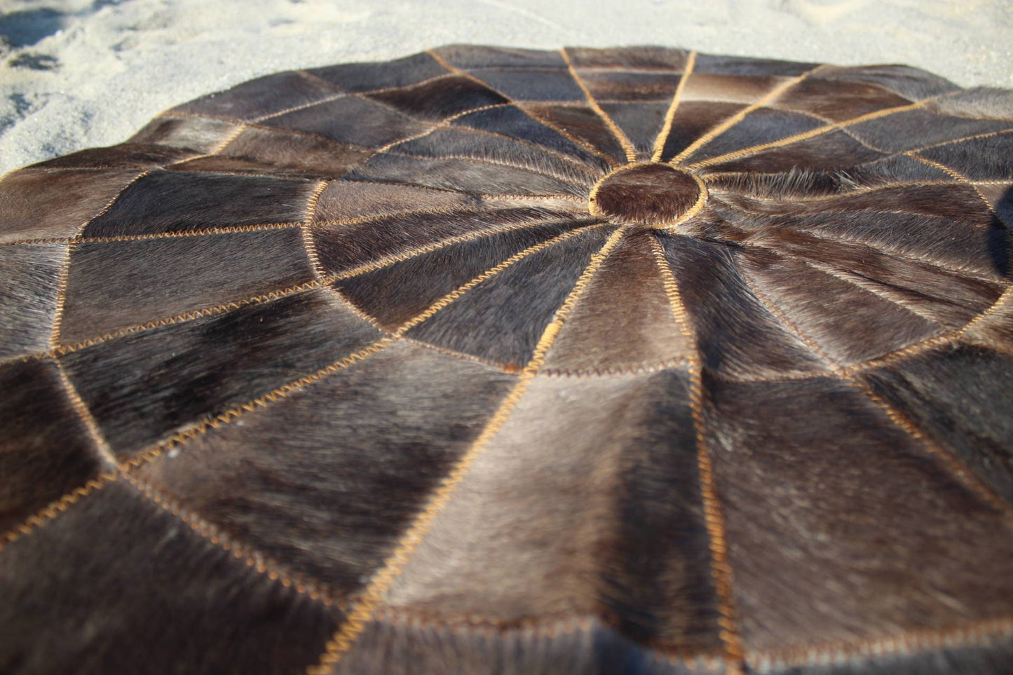 32 inch Wildebeest Hide Patchwork Rug. Authentic Dark leather patches, Star pattern on circle design with over lock joining. African Decor