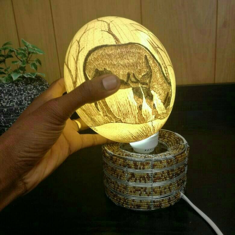 Glass beads ostrich eggs stand/ lamp holder. Beaded vases can be made according to your colors/ design preference. Bead and wire lampshades