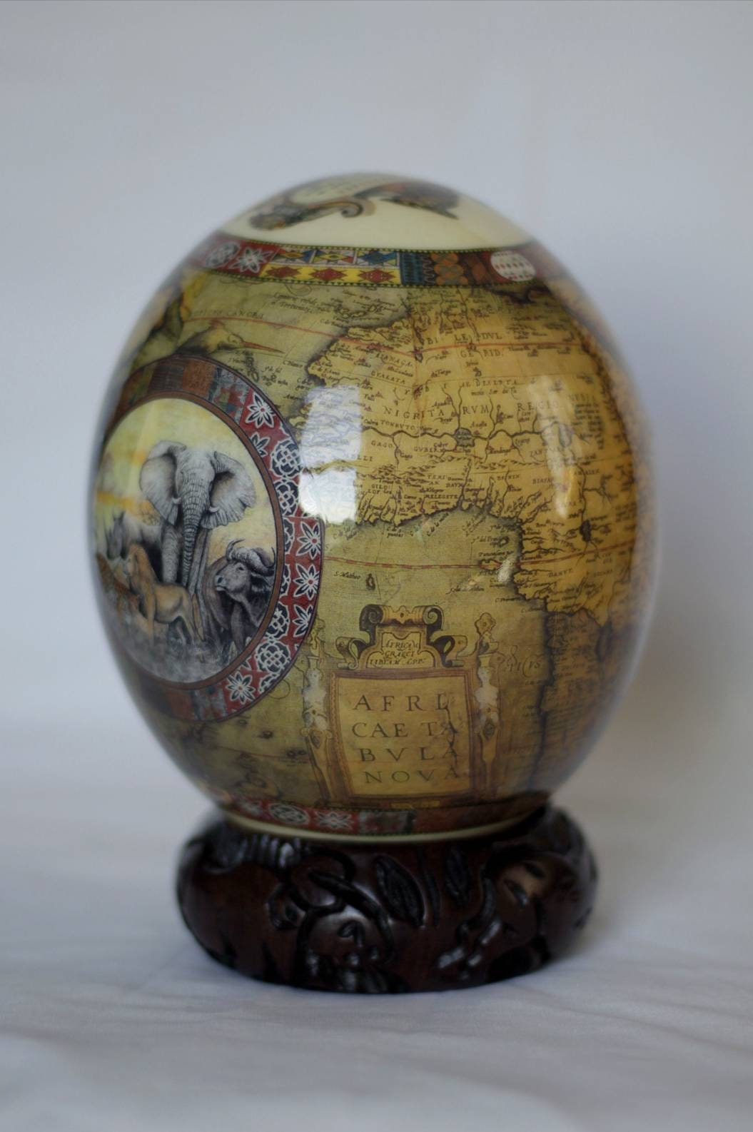 Brown Ostrich Egg Decoupage Art for home and office decoration gifts. Has African Map and big 5 Animals. Comes with a Carved Wood Ring stand