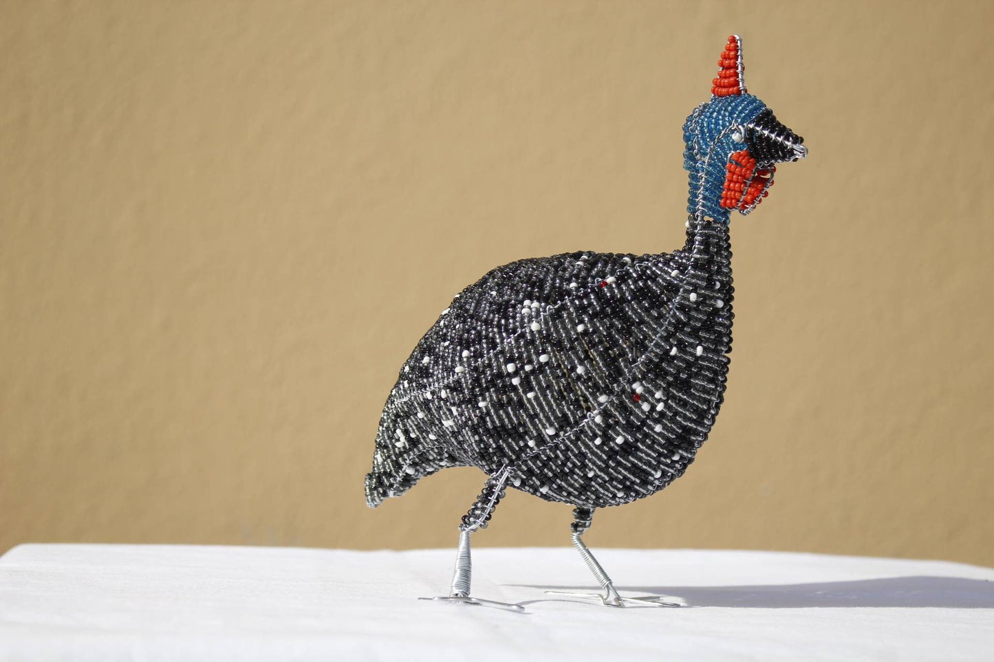 20cm Tall beaded Guinea Fowl Sculpture. Black, white, grey beads and wire handmade by Job Guwhe. African Art gifts/Souvenirs. Ships Express