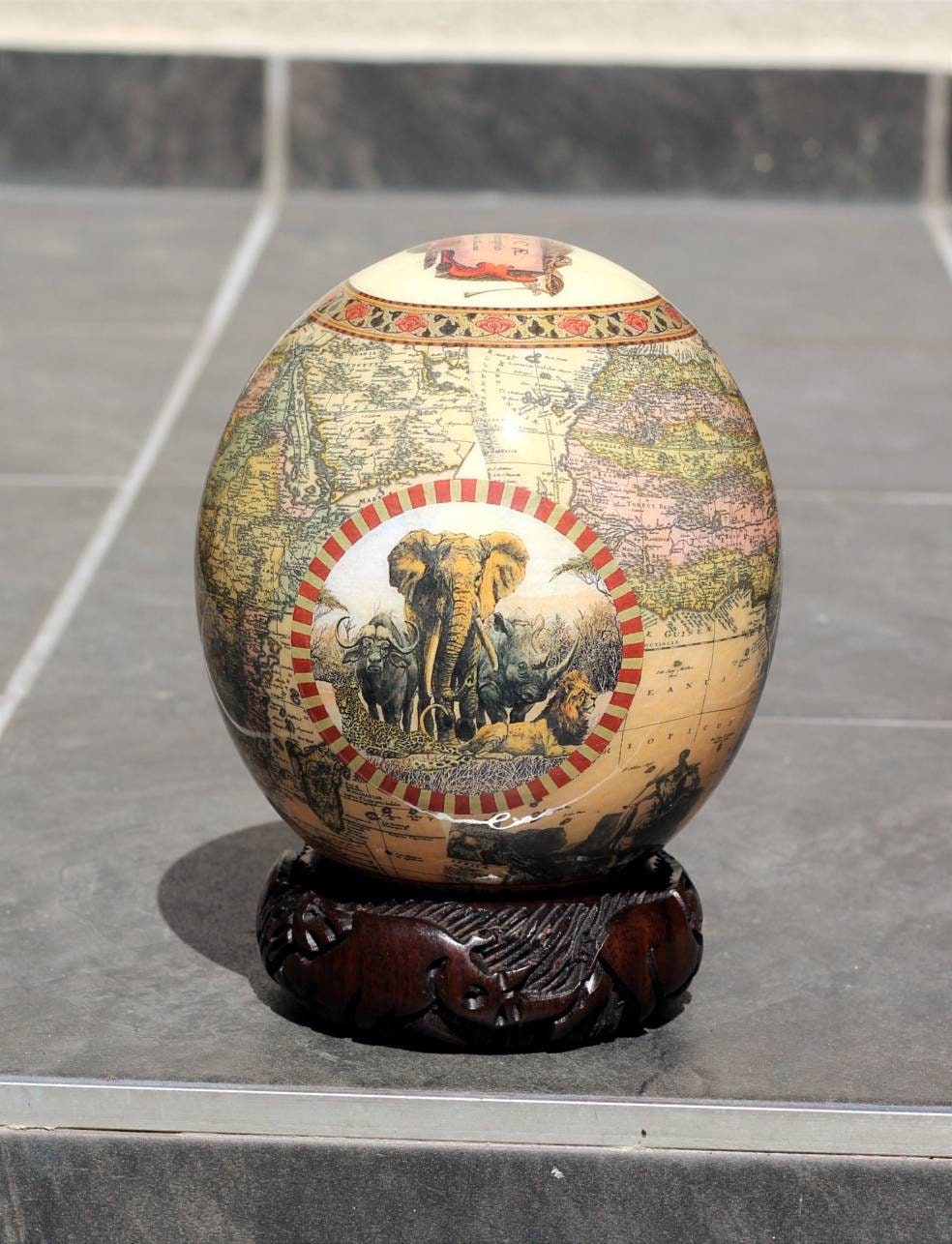 Ostrich Egg Decoupage art with African Map and Big Five Animals on a dashed maroon Circle. Brown Unique gifts Decor, with carved wood stand