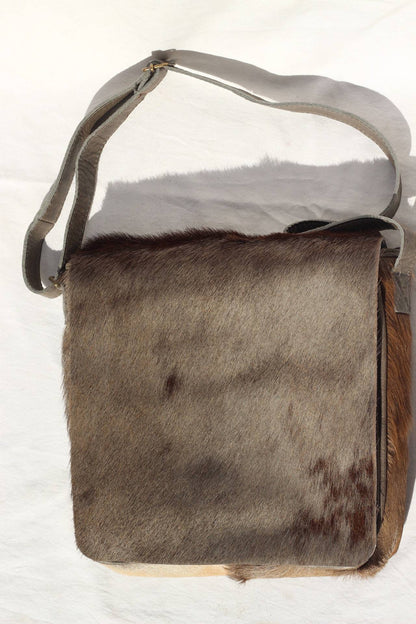 Premium Leather Mix of Wildebeest, Black Springbok and Cow Hides Sling bag Gift. Brown fur with light army Green back and Adjustable Strap.