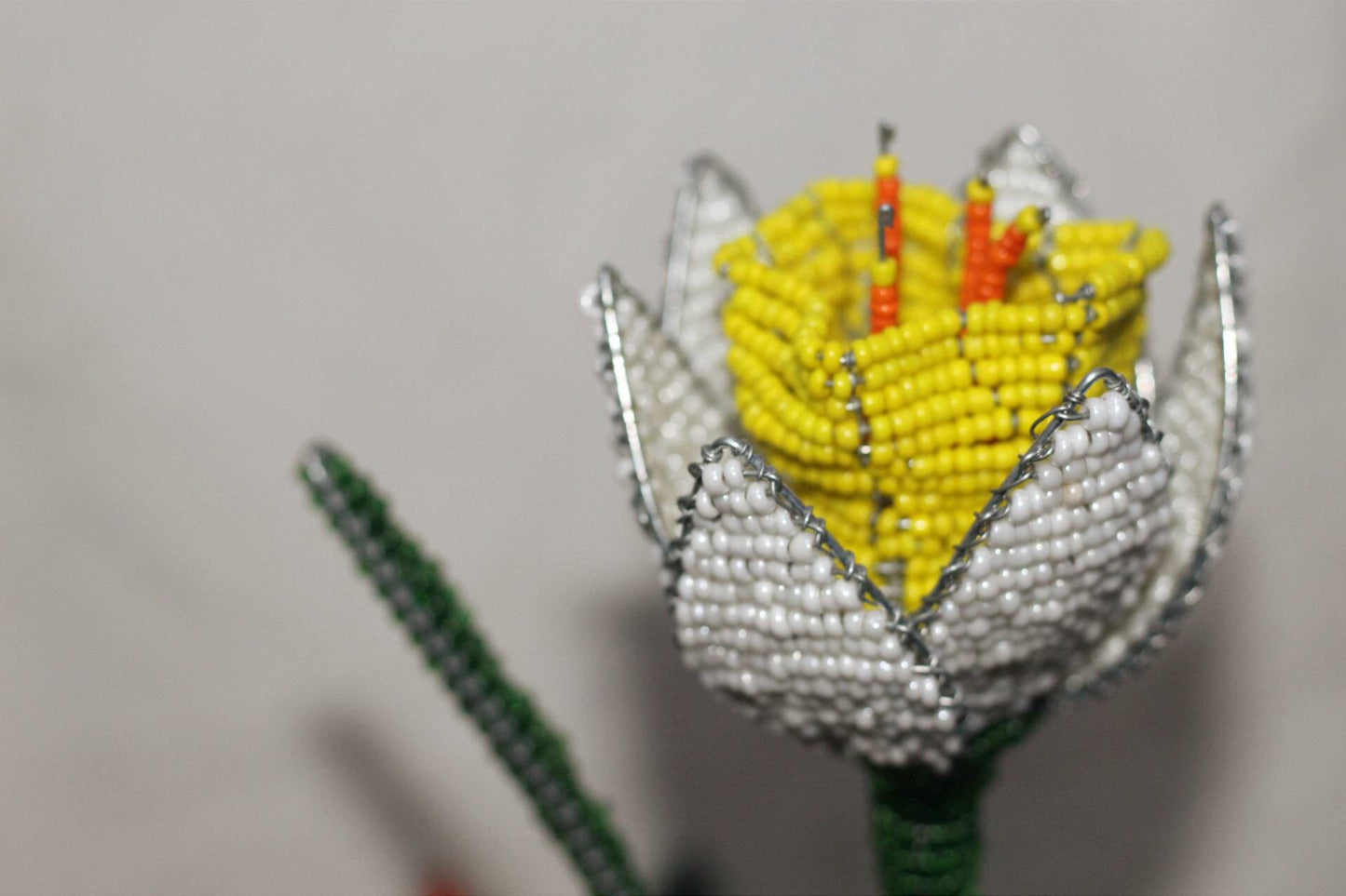 Set of 7 Beaded Flowers by Job Guwhe. 2 Roses, 2 Peace Lillies, 1 Sunflower, 1 White Daffodil, 1 Strelitzia/Bird of Paradise. African Decor