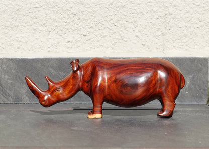 Zambian Teak wood Rhino Sculpture. Handcarved Rhinoceros figurines made from a reddish brown Wood with amazing visible grains. Ships Express