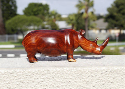 Zambian Teak wood Rhino Sculpture. Handcarved Rhinoceros figurines made from a reddish brown Wood with amazing visible grains. Ships Express