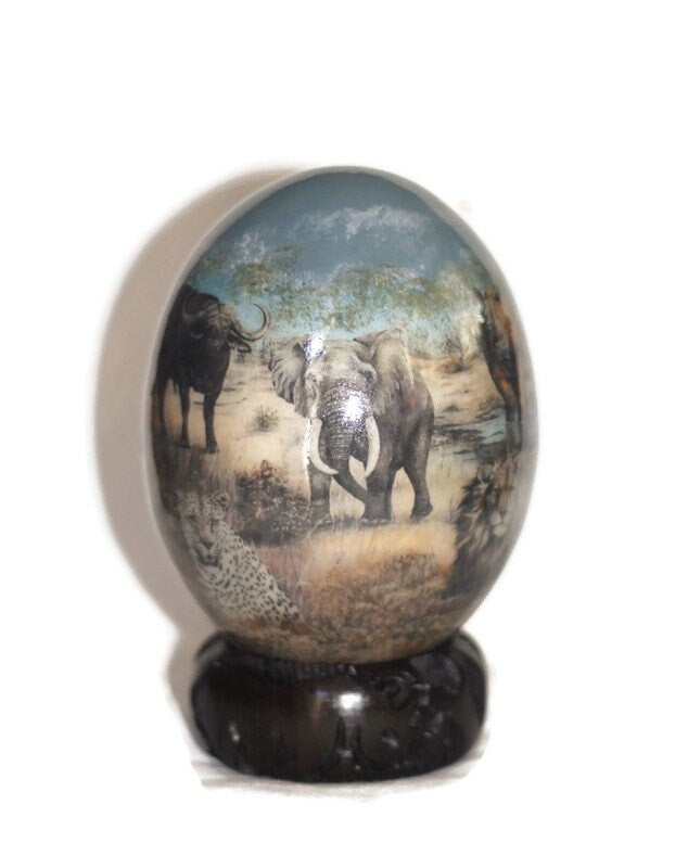 Decoupage Ostrich Egg African Big 5 animals on a Dark Blue Gray Sky Forest Background. Comes with a Malawian Wood ring stand. Ready to Ship