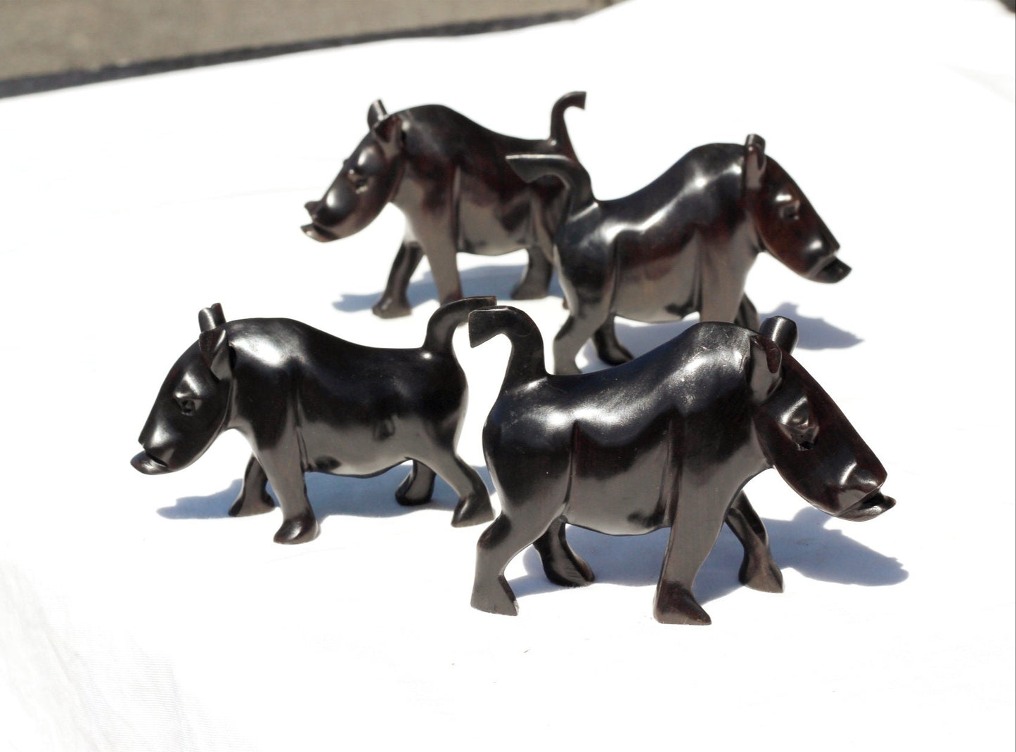 Glattes Set mit 4 Wildschwein-/Warzenschweinfiguren aus echtem Ebenholz, handgeschnitzt. Sambische Wildtierschnitzerei. Afrikanische Kunst, Weihnachtsgeschenke