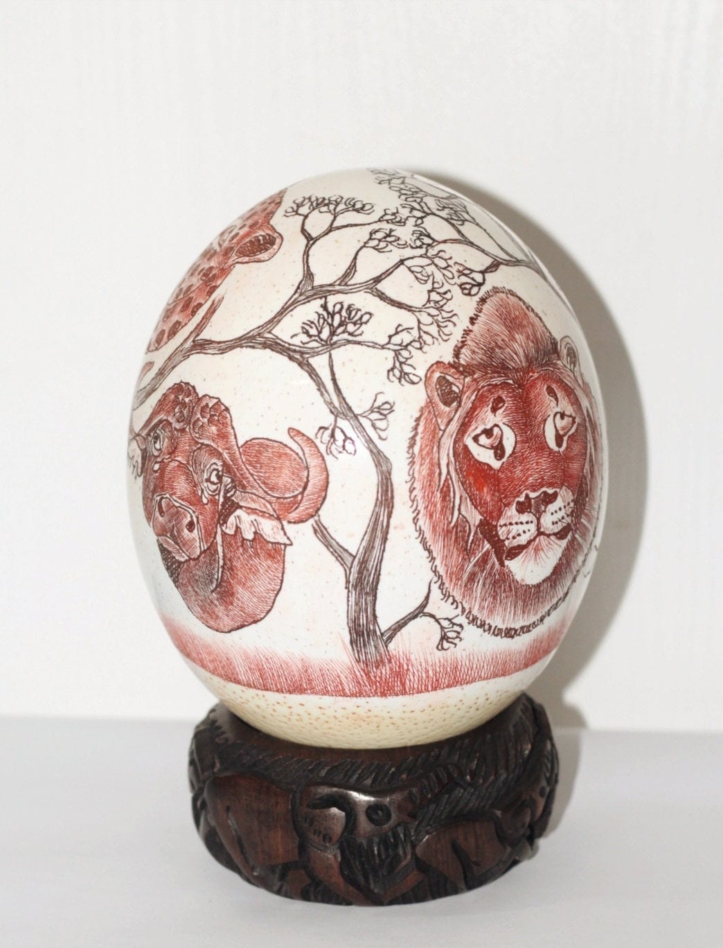 Ostrich Egg Fine Art Scrimshaw featuring the African Big 5 Heads. Burnt Amber and Toney Red Authentic Ostrich Egg Painted Safari Carving.