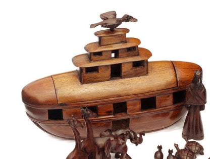 Noah's Ark Iron Wood Malawian handcarved masterpiece. 21 pieces animals pairs figurines including Noah and a dove landing on top of the Ark.