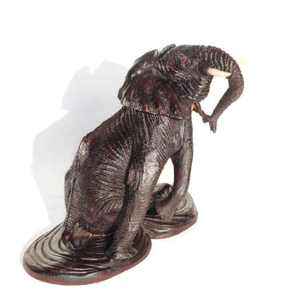 Ironwood lifelike Seating Looking Up Elephant fully detailed Masterpiece on a Wooden base. Zimbabwean Handcarved Dark brown Office/Home Deco