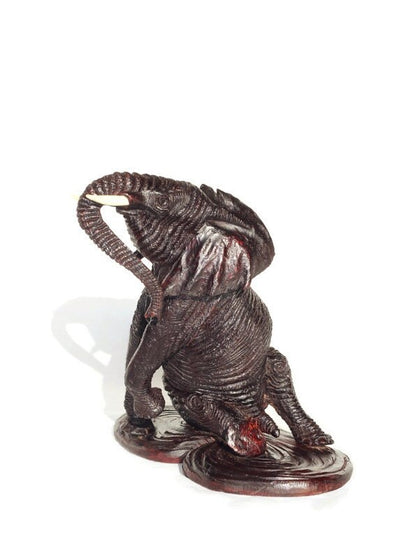 Ironwood lifelike Seating Looking Up Elephant fully detailed Masterpiece on a Wooden base. Zimbabwean Handcarved Dark brown Office/Home Deco