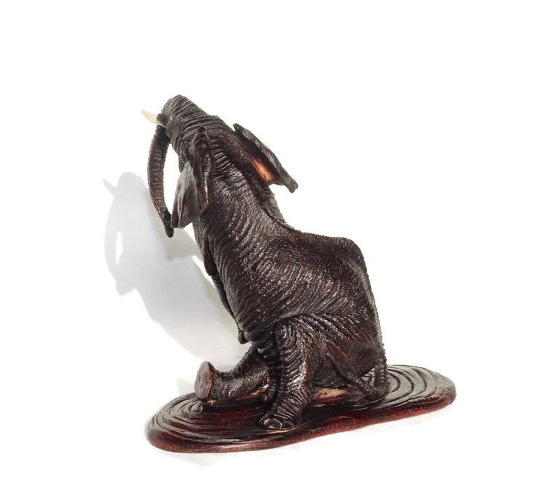 Ironwood lifelike Seating Looking Up Elephant fully detailed Masterpiece on a Wooden base. Zimbabwean Handcarved Dark brown Office/Home Deco