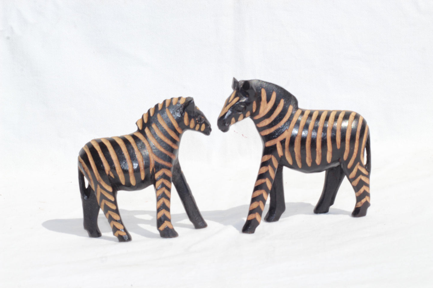 Paar Zebrafiguren aus Olivenholz. Handgemachte, aus Kalium polierte und ausgehöhlte Tierskulptur aus Simbabwe. Expressversand weltweit