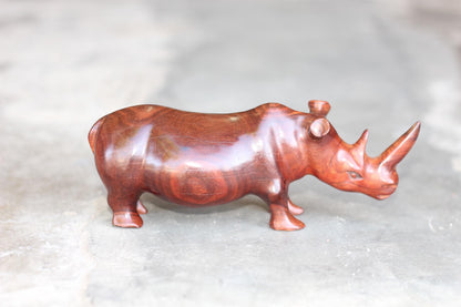 Zambian Teak wood Rhino Sculpture. Handcarved Rhinoceros figurines made from a reddish brown Wood with amazing visible grains.