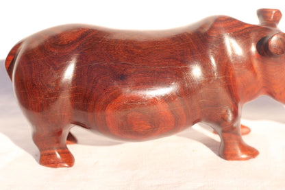 Zambian Teak wood Rhino Sculpture. Handcarved Rhinoceros figurines made from a reddish brown Wood with amazing visible grains.
