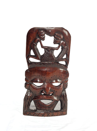 African Man Face Self Standing Mask with villagers performing chores Carvings. Handcarved interior decor tribal art. Brown iron Wood Decor.
