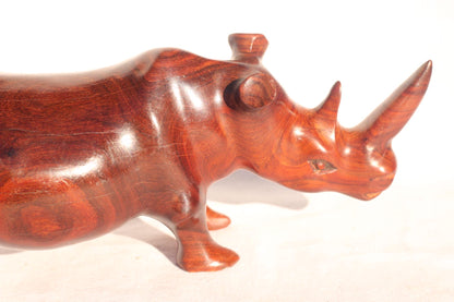 Zambian Teak wood Rhino Sculpture. Handcarved Rhinoceros figurines made from a reddish brown Wood with amazing visible grains.