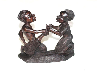 African Village Couple love story. Wife helps husband by removing thorns after working. Handmade Ironwood African Art Sculptures/Figurines.
