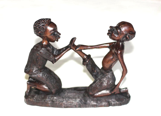 African Village Couple love story. Wife helps husband by removing thorns after working. Handmade Ironwood African Art Sculptures/Figurines.